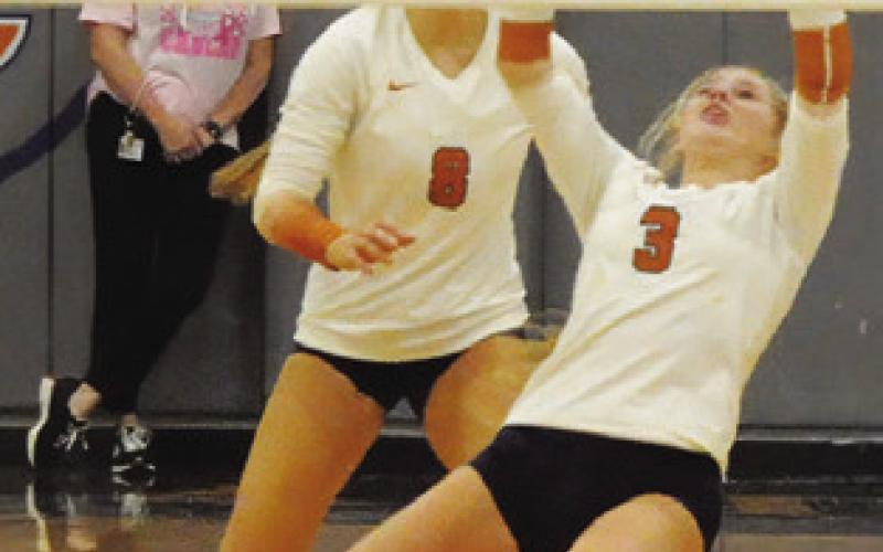 MAYZI WITHERWAX keeps the ball alive while Tatum Supak looks on. Tribune photo by Denise Squier