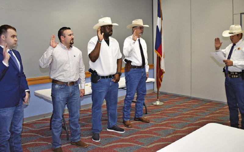 BURLESON COUNTY SHERIFF Bill Rios, rights, swears in these these deputies on Monday. They include, from left, Dylan Bryant, a TEEX Academy cadet, Bern Collum III, patrol deputy, Jerome Plair, investigator, and David Simmons as chief deputy.