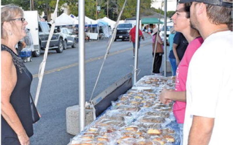 A CUSTOMER ENJOYS plenty of choices at a kolache sales booth last Saturday at the Kolache Festival. -- Tribune photo by Roy Sanders