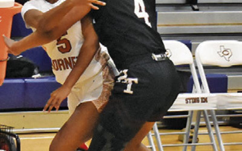 AYANNA DEWBERRY passes the ball to a teammate during the Lady Hornet Classic. Tribune photo by Roy Sanders