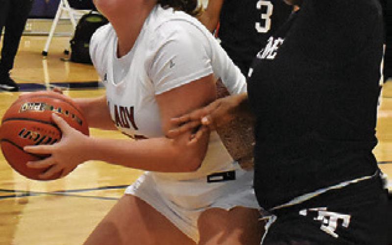 CLARK eyes the basket while a Hearne player defends during the Lady Hornet Classic at Hornet Gym in Caldwell. Tribune photo by Roy Sanders