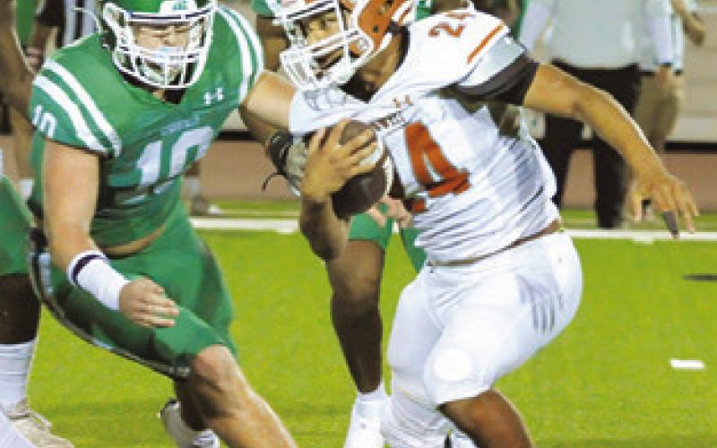 ADIAN TORRES of Caldwell carries the ball against Cuero in the Hornets loss last Friday.