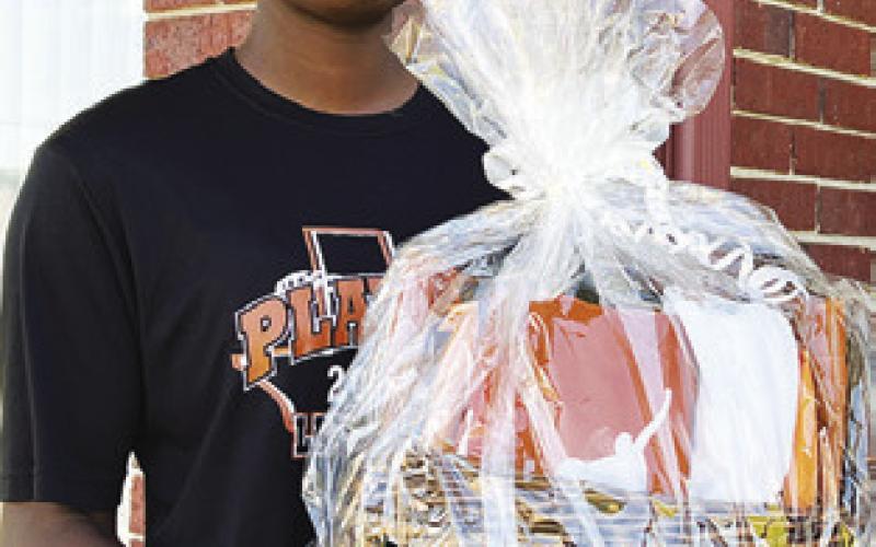 CALDWELL’S MESHA JOHNSON holds a basket full of Texas Longhorn items which is being raffled off to help fund her trip to Oklahoma City, Oklahoma, to play in the USA Softball All-American Games on Aug. 8-11.