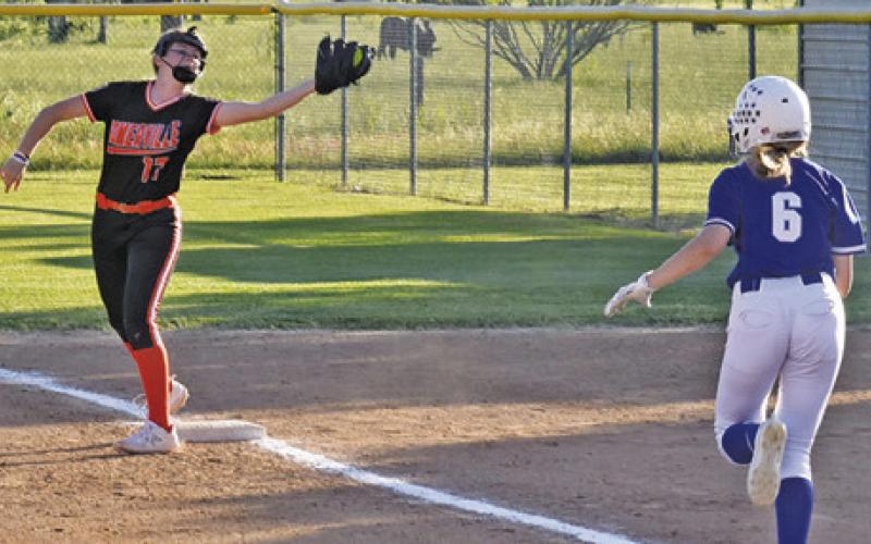 SOMERVILLE’S KYLIE NEUENDORFF catches the ball for a force out while Snook’s Kylie Price runs towards first base.