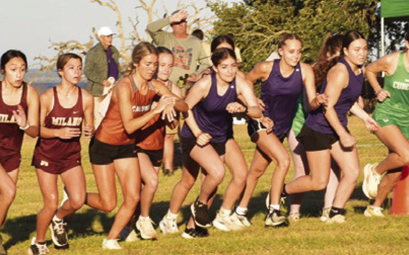 CALDWELL GIRL CROSS country runners Hannah Muzny and Fallyn Anderson leave the starting line for the girls varsity race at Saturday’s Yegua Invitational Cross Country Meet. Tribune photo by Roy Sanders