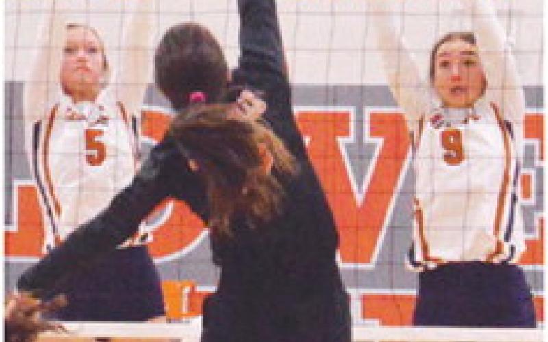 CALDWELL’S KYSEN TONEY and Natalie Eastepp jump to attempt to block a Smithville hit at the net. -- Tribune photo by Roy Sanders