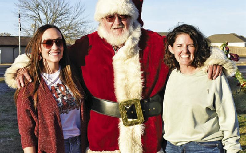 LAUREN WILLIAMS AND Jamie Hardin with the Snook Education Foundation join Santa Claus at the Bluejay Trail of Lights.