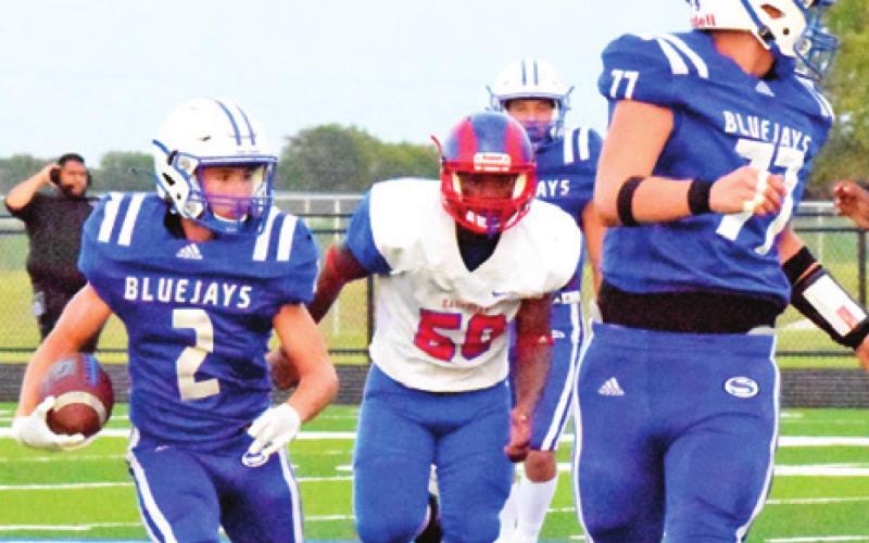 LANCE LARA OF Snook carries the ball for Snook as teammate David Toler blocks. -- Tribune photo by Bailey Brown.