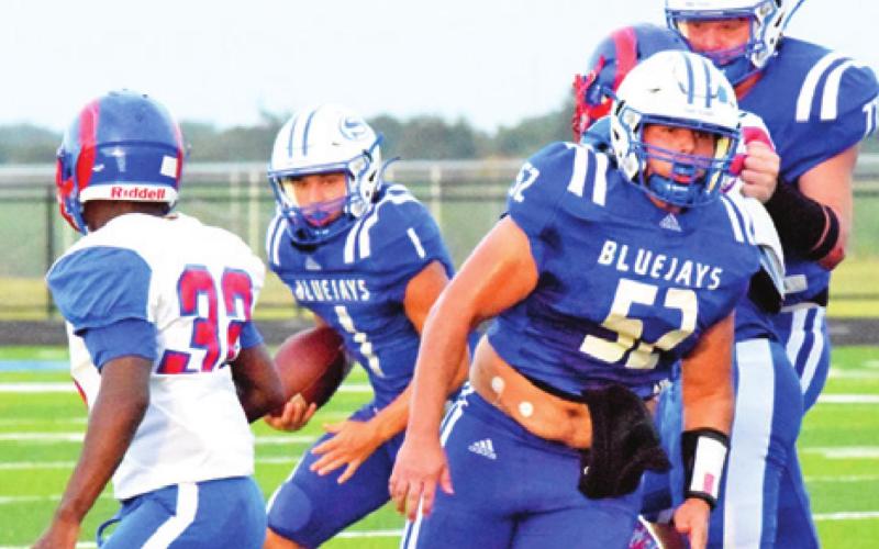 SNOOK QUARTERBACK GARRETT Lero carries the ball against Kashmere. Also pictured are David Toler and Cody Noriega.