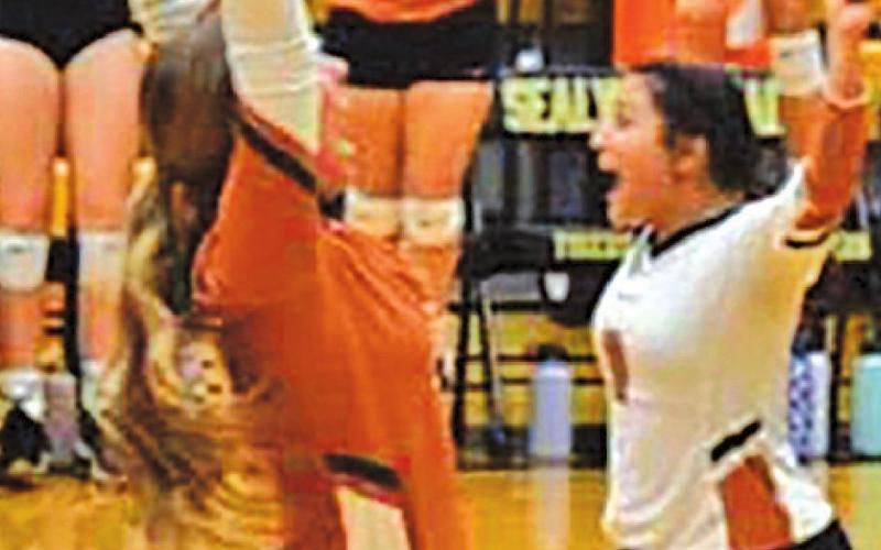 THE LADY HORNETS celebrate after beating Sealy on the road last Friday night.