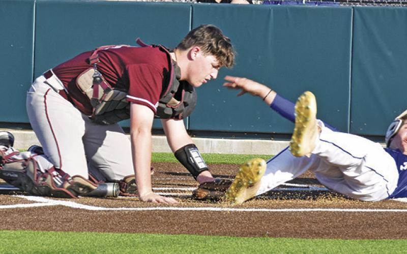 SNOOK’S CADEN SCHLUENS slides into home against Iola.