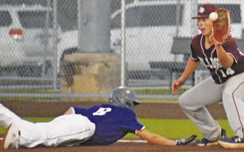 GABRIEL LACAZE SLIDES back into first base against Iola.