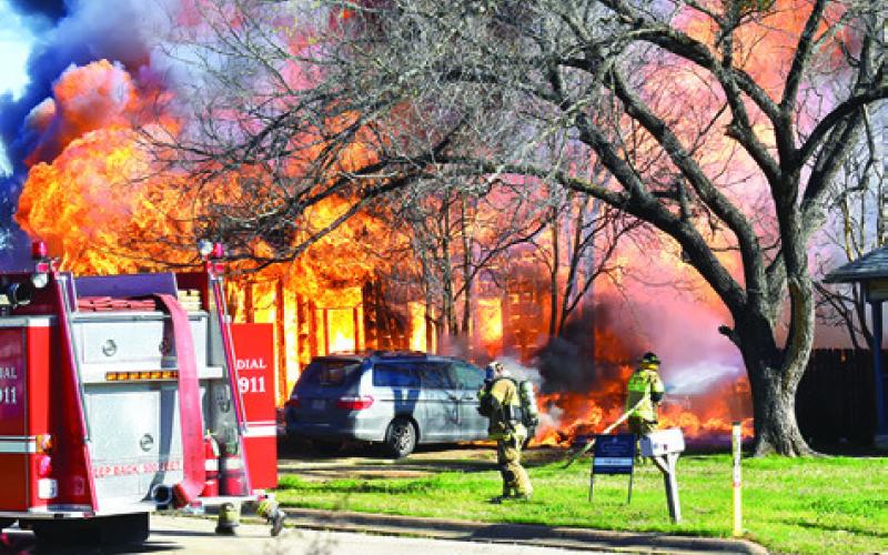 FIREFIGHTERS BATTLE THE fire near the van.