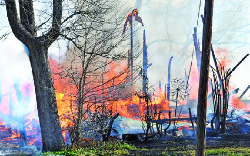THE FIRE BURNS down the last of this house at 508 N. Hill Street in Caldwell early Sunday. -- Tribune photo by Roy Sanders