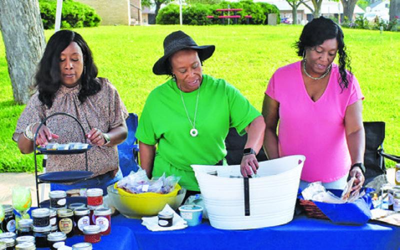 DAPHNE NIX-MONROE, Sheila Nix and Tiffany Lee work at the D’s Blessings vendor table on Saturday, May 4, in downtown Caldwell.