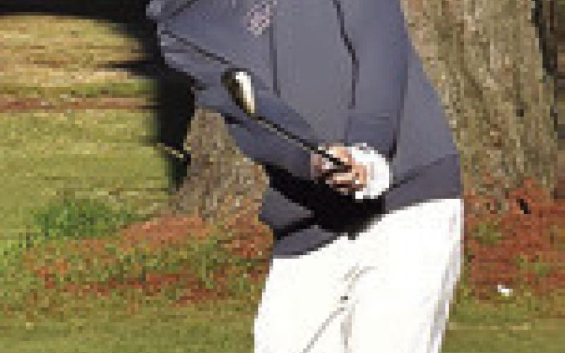 NATHAN SCOTT chips to the pin on Monday at Copperas Hollow Country Club in Caldwell. The meet was hosted by Lexington.