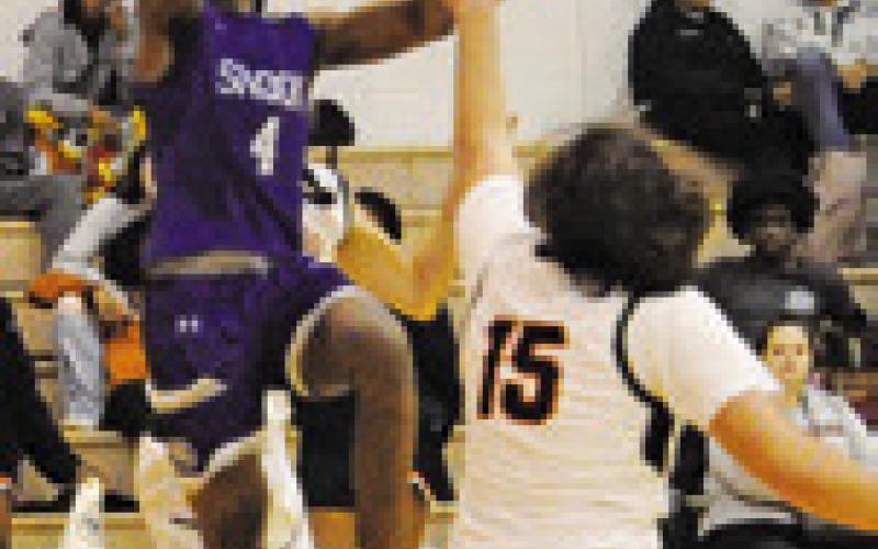 SNOOK’S JOHN Carr takes a shot while Somerville’ Irman Sadic defends. Tribune photo by Denise Squier