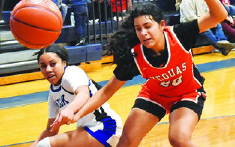 ALANA STRINGFELLOW and Annette Reyna fight for possession of the ball during the Snook-Somerville game last Friday in Snook. Tribune photo by Roy Sanders