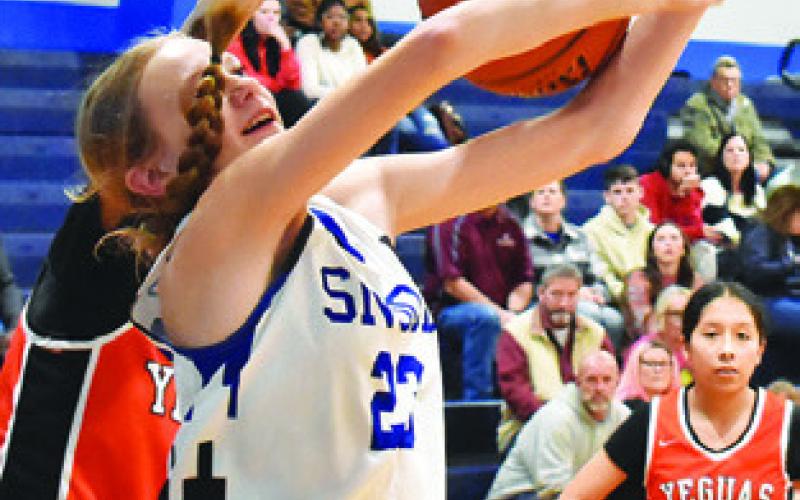 DAKOTA KIENOW is fouled while going for the ball during the Snook-Somerville game last Friday in Snook. Tribune photo by Roy Sanders