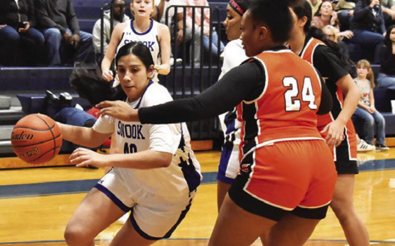 SNOOK’S KARLA LARA drives the lane while Somerville’s Keira Moore defends during the Snook-Somerville game last Friday. Tribune photo by Roy Sanders