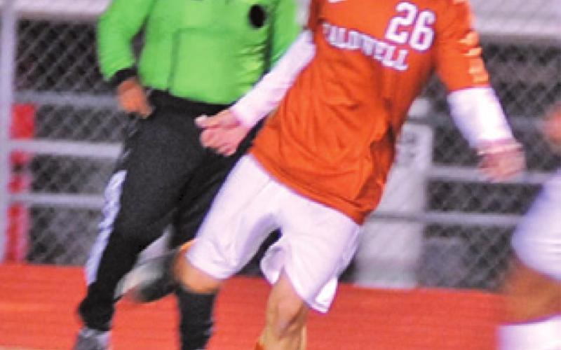 ALEXANDER REYES sets to pass the ball to another Hornet player during the Caldwell-Bellville game last Friday night.
