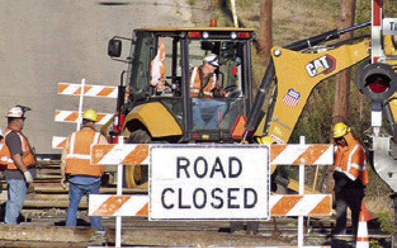 CREWS FROM Union Pacific Railroad work on the tracks last Friday on Harvey Street.