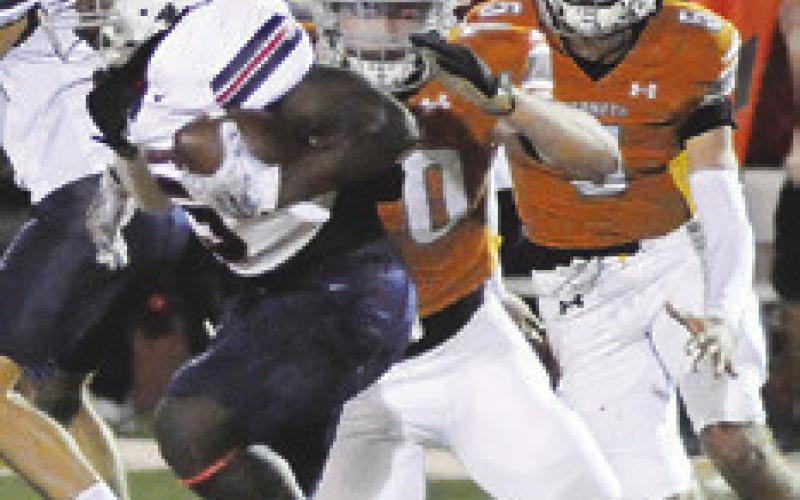 THE CALDWELL Hornet defense moves in for a tackle against Madisonville. Tribune photo by Denise Squier
