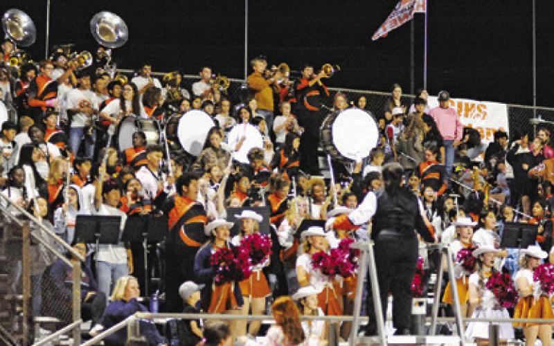 THE CALDWELL HIGH SCHOOL BAND is joined by the Caldwell Junior High Band to perform music in the stands during the Caldwell-Madisonville football game last Friday.