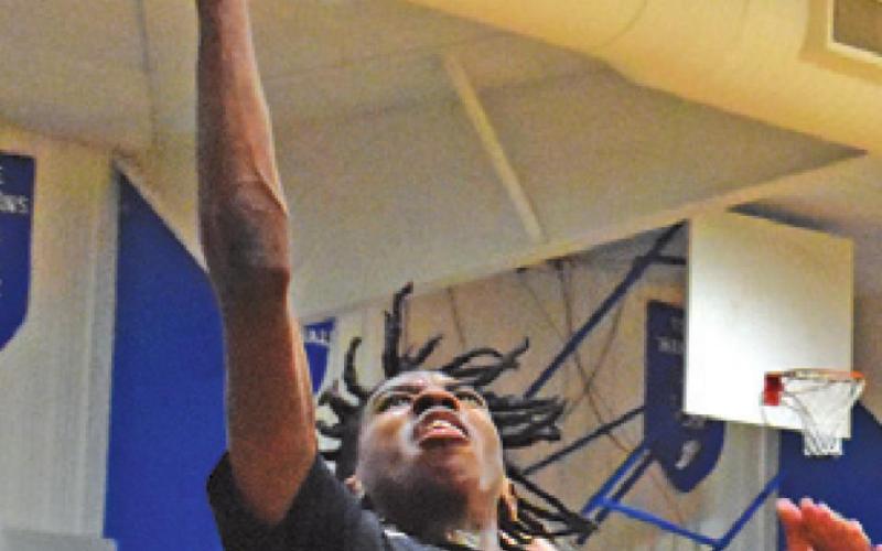 BRANDYN CARTER of Somerville takes a shot against Snook. Snook won 70-51.