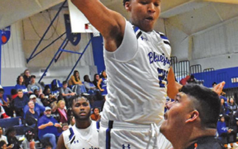 JESUS ESPINOZA of Somerville takes a shot as Snook’s Dekendrick Dawson and Tavarean Grimes defend. Snook won 70-51.