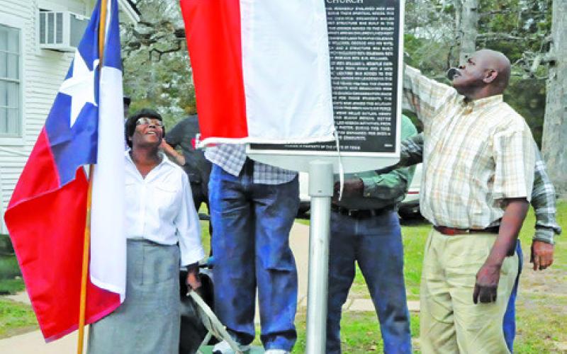 THE NEW TEXAS HISTORICAL marker at Shiloh Missionary Baptist Church is being unveiled during a ceremony on Saturday. Tribune photo by Denise Squier