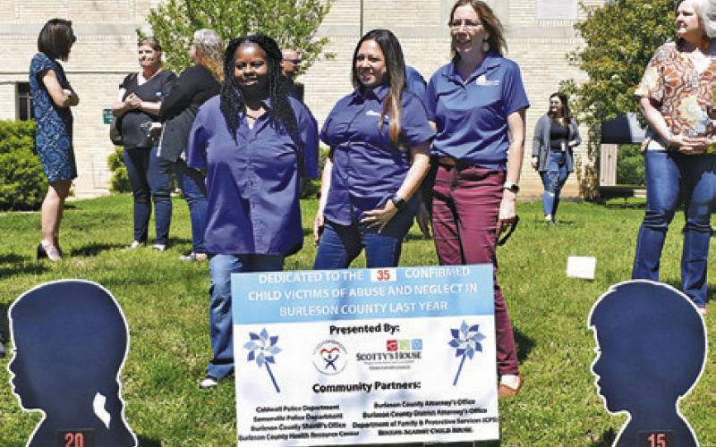 BARBARA VINCENT, FELISHA Tapia and Jodi Olive of the Burleson Health Resource Center stand behind the sign at the ceremony.