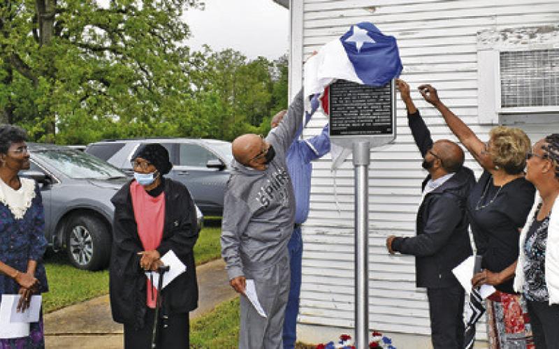 CHURCH MEMBERS UNVEIL this Texas Historical Marker at St. Matthew Missionary Baptist Church on Saturday, April 5. They include Wilma Hanks, Hazel Bryant, Melvin Morris, Caster Washington, Hubert Morris Jr., Ruthie Pollard Ellison and Grace Wilson. Tribune photo by Roy Sanders