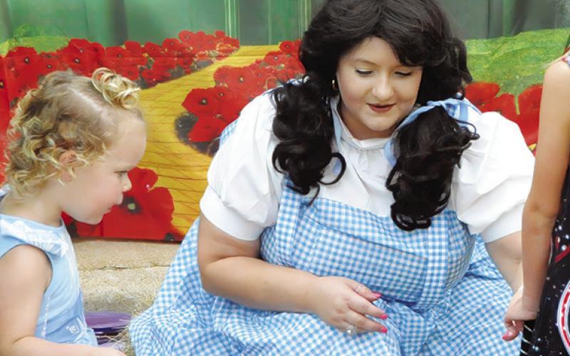 THERE’S NO PLACE LIKE HOME, except maybe at Saturday’s “Scare on the Square” where even Dorothy from The Wizard of Oz made an appearance to pass out candy to area children. Tribune photo by Denise Squier