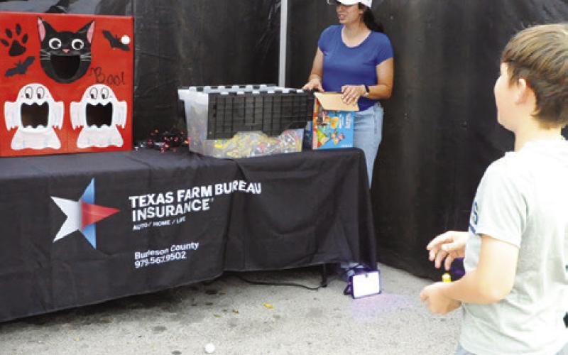 SOME “SCARE ON THE SQUARE” booths hosted games for children to earn extra goodies during Saturday night’s event. Tribune photo by Denise Squier