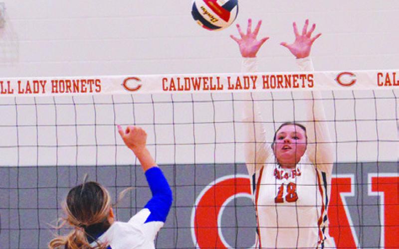 CALDWELL’S KIERSTYN MACIK attempts to block a hit from a Navasota player during the Lady Hornets’ win on Friday at home. Tribune photo by Kimberly Hutcheson