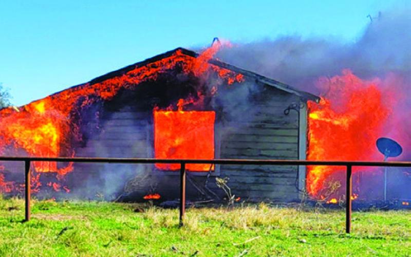 THE FIRE BURNS at this unoccupied house on County Road 244. Photo courtesy of Snook VFD