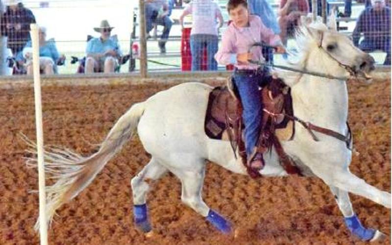 THIS RIDER IS COMPETING IN THE poles event during the Burleson County Youth Rodeo at the fairgrounds on Friday, sponsored by the Burleson County Saddle Club. -- Tribune photo by Denise Hornaday