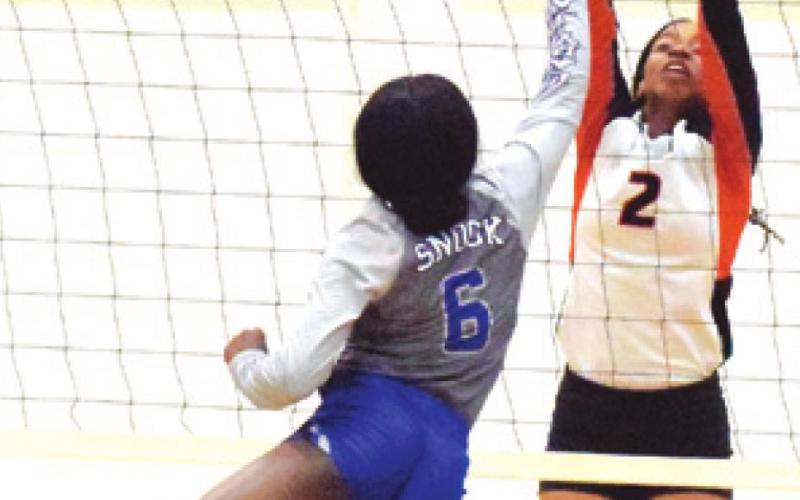 SOMERVILLE’S RA’MAYA CARTER blocks the hit by Snook’s Breanna Louis during the Lady Yeguas win over the Lady Jays last week.
