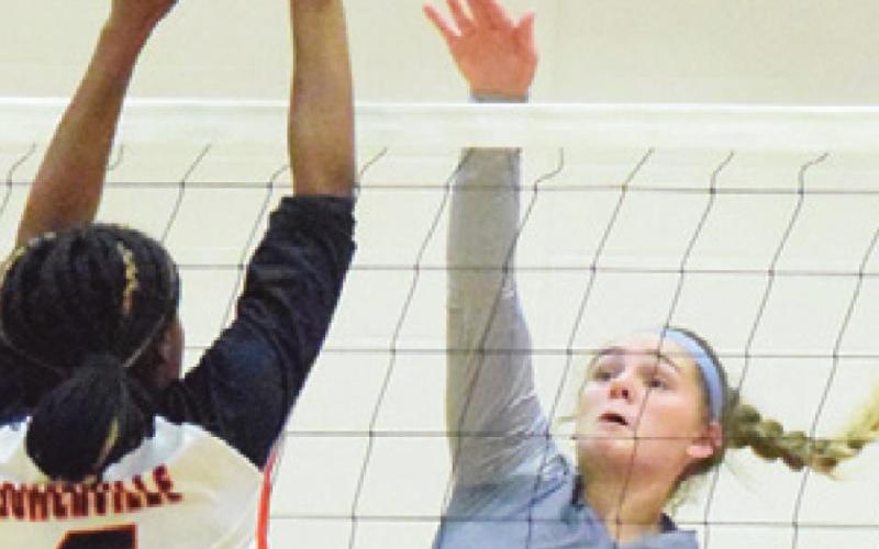 CAMIA MARTIN reaches to block the hit from Alexis Macik during the Somerville-Snook rivalry match last week in Somerville.