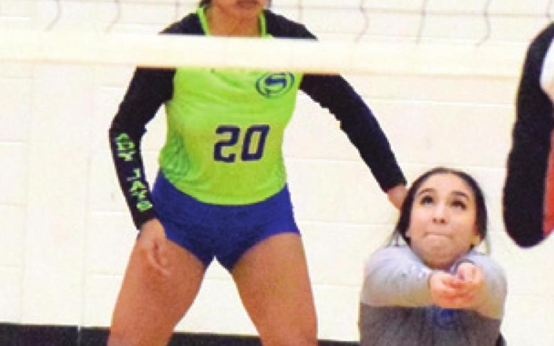 SNOOK’S NADIA GARCIA bumps the ball while her teammate Frida Mota looks on.