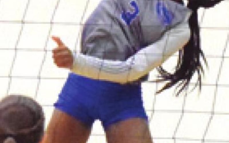 BRE’ASIA LOUIS hits the ball while Somerville’s Emma Kovasovic waits to return.