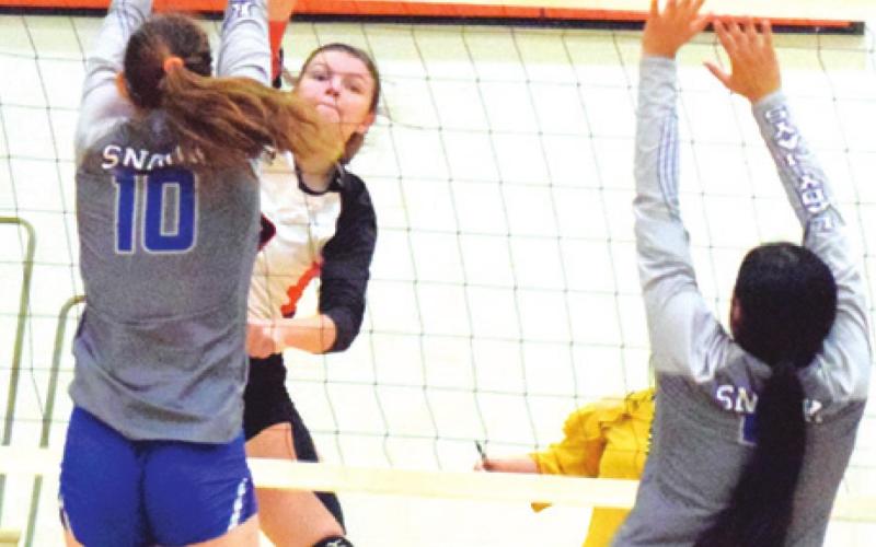 SOMERVILLE’S EMMA KOVASOVIC hits the ball past Snook’s Payton Sodolak and Karla Lara. -- Tribune photo by Denise Squier