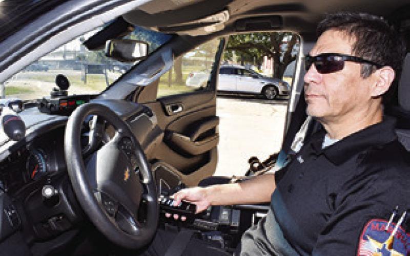 SNOOK POLICE CHIEF Steve Huron checks out new equipment for the police vehicle.