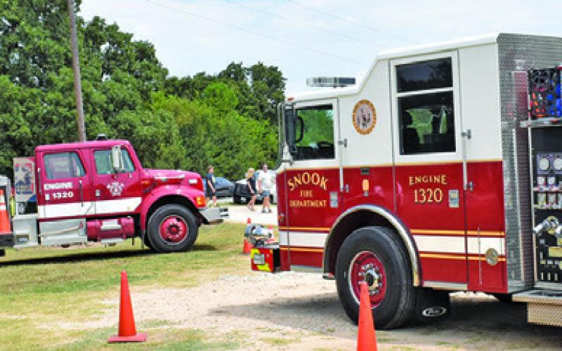 FIRETRUCKS WERE PARKED outside the Snook SPJST Hall during their annual barbecue fundraiser. The event always draws a good crowd of supporters for the fire department.