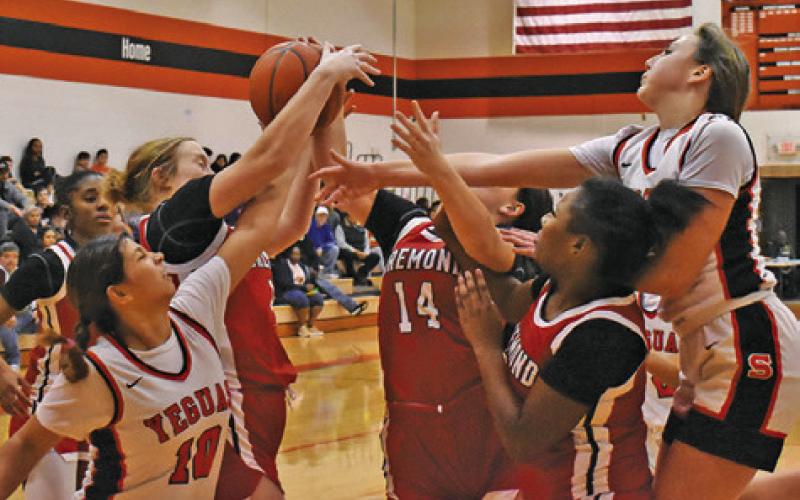 LADY YEGUAS CAPRI ALEJANDRO and Abigail Richardson fight with several Bremond players for a rebound during the Somerville-Bremond game last Friday night in Somerville. Tribune photo by Roy Sanders