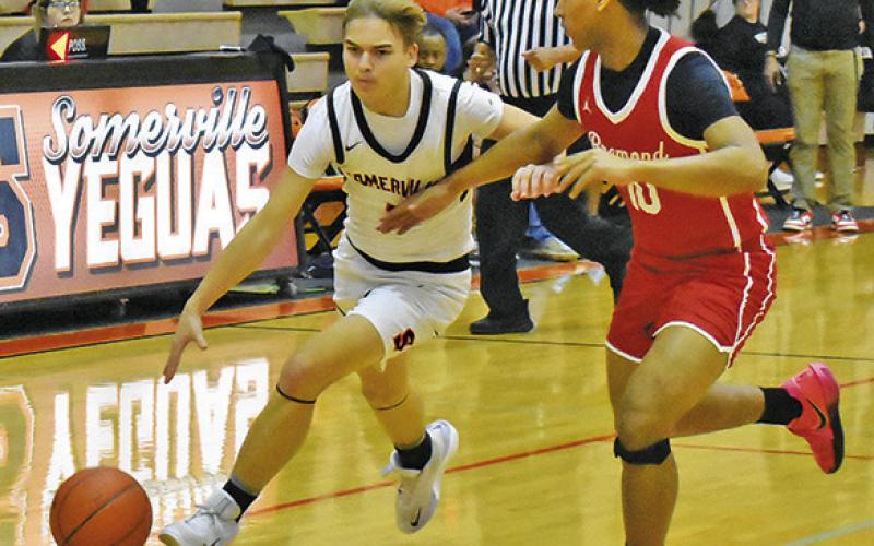 J.J. MOSES DRIBBLES the ball past this Bremond defender in last Friday’s game in Somerville. The Yeguas lost 56-28 and 75-65 on Tuesday, Jan. 27, at Iola. Tribune photo by Roy Sanders