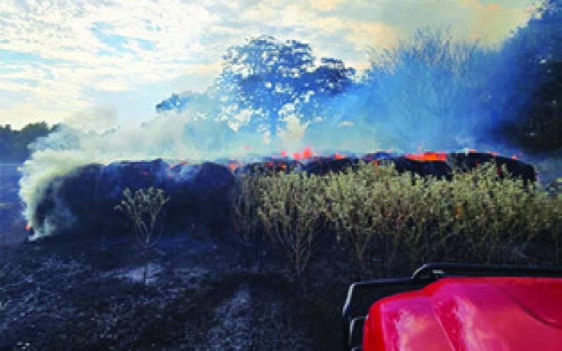 THESE HAY bales burn on Aug. 25 on Private Road 2011 off County Road 333. Photo courtesy of Caldwell VFD