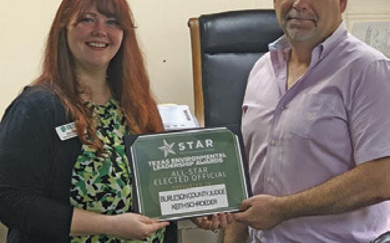 BURLESON COUNTY Judge Keith Schroeder is presented the TELA All-Star Elected Official Award by Zoe Killian, Keep Texas Recycling program manager at Keep Texas Beautiful.