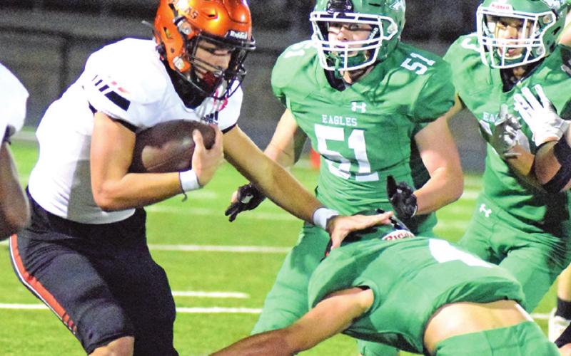 SOMERVILLE QUARTERBACK Johnny Legg stiff arms Eldorado’s Korbin Covarrubiaz while a flock of Eldorado Eagles follow in pursuit. Schedule